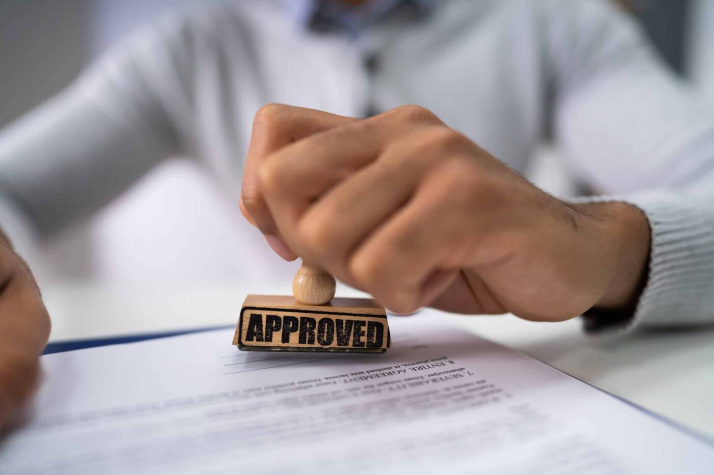 Buy 2 First Time Home Buyer Georgia: Pre Approval | Close-up Of A Person's Hand Stamping With Approved Stamp On Document At Desk